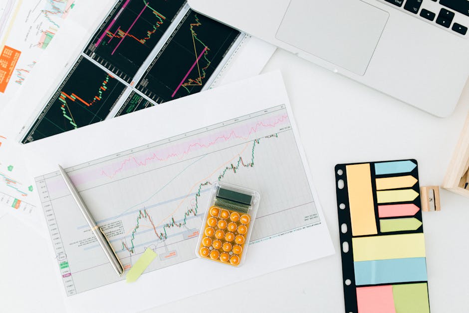 Flat lay of financial charts and tools on office desk, ideal for business and finance concepts.